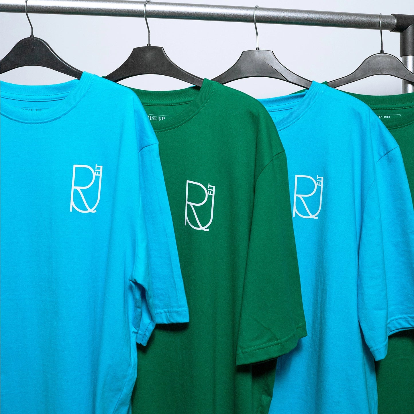 Rise_up_fit_oversized_t-shirts_in_blue_and_green_on_the_rail